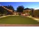 Landscaped backyard with fire pit and string lights at 3617 E Half Hitch Pl, Phoenix, AZ 85050