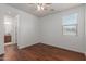 Well-lit bedroom with hardwood floors and access to bathroom at 3617 E Half Hitch Pl, Phoenix, AZ 85050