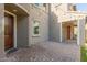 Brick paved courtyard with string lights and two wooden doors at 3617 E Half Hitch Pl, Phoenix, AZ 85050