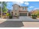 Two-story house with a green garage door and landscaped front yard at 3617 E Half Hitch Pl, Phoenix, AZ 85050