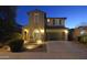 Two-story house with a green garage door, illuminated at night at 3617 E Half Hitch Pl, Phoenix, AZ 85050