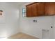 Laundry room with wood cabinets and vinyl flooring at 3617 E Half Hitch Pl, Phoenix, AZ 85050