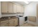 Laundry room with washer, dryer, and built-in cabinets at 37 W Sierra Vista Dr, Phoenix, AZ 85013