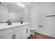 Modern bathroom featuring double sinks, sleek white cabinetry, and contemporary fixtures at 4120 E Ghost Flower Ln, San Tan Valley, AZ 85140