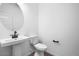 Stylish powder room featuring a pedestal sink, modern faucet, and tile flooring at 4120 E Ghost Flower Ln, San Tan Valley, AZ 85140