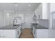Bright kitchen featuring an island, white cabinets, and stainless steel appliances at 4120 E Ghost Flower Ln, San Tan Valley, AZ 85140