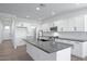 Bright kitchen featuring an island, white cabinets, and stainless steel appliances at 4120 E Ghost Flower Ln, San Tan Valley, AZ 85140