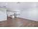 Open living space with wood-style tile flooring leading into a bright kitchen at 4120 E Ghost Flower Ln, San Tan Valley, AZ 85140