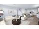 Open-concept living space featuring a sofa, chairs, art, with seamless kitchen and dining access at 4120 E Ghost Flower Ln, San Tan Valley, AZ 85140