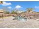 Inviting backyard oasis featuring a sparkling pool, waterfall, and spacious patio at 4229 E Seasons Cir, Gilbert, AZ 85297