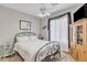 Well-lit bedroom with full-size bed and wooden storage cabinet at 4229 E Seasons Cir, Gilbert, AZ 85297