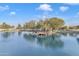 Serene lake with a wooden dock and lush trees at 4229 E Seasons Cir, Gilbert, AZ 85297