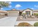 Single-story home with a two-car garage and desert landscaping at 4229 E Seasons Cir, Gilbert, AZ 85297