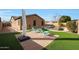 Landscaped backyard showcasing artificial grass and brick patio surrounding the pool, creating an inviting outdoor living space at 433 N Neuman Pl, Chandler, AZ 85225