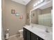 Bathroom featuring a double vanity with black cabinetry and a large mirror at 433 N Neuman Pl, Chandler, AZ 85225