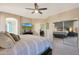 Bright bedroom showcases a ceiling fan, view to a bathroom, and mirrored closet doors at 433 N Neuman Pl, Chandler, AZ 85225