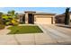 Charming single-story home with well-manicured lawn and a two-car garage at 433 N Neuman Pl, Chandler, AZ 85225