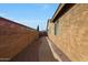 Exterior view of the home highlighting the side yard with a pathway and low-maintenance landscaping at 433 N Neuman Pl, Chandler, AZ 85225