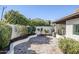 Landscaped backyard with a curved planter and tile patio at 4701 E Ardmore Rd, Phoenix, AZ 85044