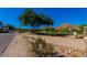 Community entrance with a tree, landscaping, and mountain views at 4701 E Ardmore Rd, Phoenix, AZ 85044