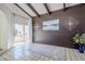 Living room with wood-paneled accent wall and sliding glass door at 4701 E Ardmore Rd, Phoenix, AZ 85044