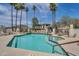 Community pool with spa, surrounded by palm trees and lounge chairs at 4701 E Ardmore Rd, Phoenix, AZ 85044