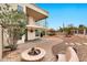 Spacious backyard featuring a brick patio, fire pit, seating, and a well-manicured garden with an American flag at 5010 E Mesquite Wood Ct, Phoenix, AZ 85044