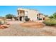 Two-story home's backyard has gravel landscaping, brick patio, and partial shade at 5010 E Mesquite Wood Ct, Phoenix, AZ 85044