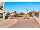 Backyard boasts gravel and brick-paved landscaping with an American flag and low block wall at 5010 E Mesquite Wood Ct, Phoenix, AZ 85044