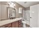 Bathroom features a single sink vanity, medicine cabinet, and combined shower and tub at 5010 E Mesquite Wood Ct, Phoenix, AZ 85044