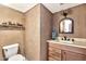 Powder room with decorative vanity, shelving, and a matching framed mirror above the sink at 5010 E Mesquite Wood Ct, Phoenix, AZ 85044