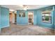 Carpeted bedroom with a ceiling fan, a painting on the wall, and an adjoining bathroom and staircase at 5010 E Mesquite Wood Ct, Phoenix, AZ 85044