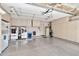 Spacious garage featuring epoxy flooring, storage cabinets, and laundry hookups at 5010 E Mesquite Wood Ct, Phoenix, AZ 85044