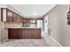 Bright kitchen featuring an island, white appliances, tile floors, and plenty of cabinet space at 5010 E Mesquite Wood Ct, Phoenix, AZ 85044