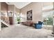 Inviting living room with soaring ceilings, a staircase, large windows, and comfortable seating at 5010 E Mesquite Wood Ct, Phoenix, AZ 85044