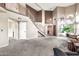 Bright, open living room featuring staircase, lots of natural light, and comfortable seating at 5010 E Mesquite Wood Ct, Phoenix, AZ 85044