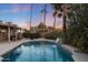 Inviting backyard oasis featuring a sparkling pool, waterfall, and pergola at 5201 E Winchcomb Dr, Scottsdale, AZ 85254