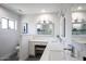 Modern bathroom with double vanity, white cabinets, and large mirror at 5201 E Winchcomb Dr, Scottsdale, AZ 85254