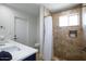 Clean bathroom with a walk-in shower, neutral tile, and double vanity at 5201 E Winchcomb Dr, Scottsdale, AZ 85254