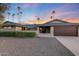 Single story home with a two-car garage and well-manicured landscaping at 5201 E Winchcomb Dr, Scottsdale, AZ 85254