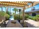 Outdoor dining area under a pergola with pool views at 5201 E Winchcomb Dr, Scottsdale, AZ 85254