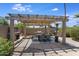 Relaxing patio with pergola, outdoor fireplace, and dining area at 5201 E Winchcomb Dr, Scottsdale, AZ 85254