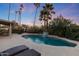 Relaxing pool area with lounge chairs and a tranquil waterfall feature at 5201 E Winchcomb Dr, Scottsdale, AZ 85254