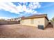 Large gravel backyard with block wall and neighboring houses visible at 541 W Prickly Pear Dr, Casa Grande, AZ 85122