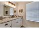 Bathroom with granite countertop, single vanity, and window at 6073 W Caribe Ln, Glendale, AZ 85306