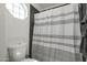 Clean bathroom with shower/tub combo and striped curtain at 6073 W Caribe Ln, Glendale, AZ 85306