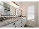 Bathroom with granite countertop, double vanity, and large mirrors at 6073 W Caribe Ln, Glendale, AZ 85306