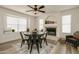 Charming dining area with wooden table, black metal chairs, and stylish light fixture at 6073 W Caribe Ln, Glendale, AZ 85306