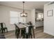 Open concept dining area with kitchen views and modern light fixture at 6073 W Caribe Ln, Glendale, AZ 85306