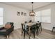 Bright dining area featuring a rustic farmhouse table and six chairs at 6073 W Caribe Ln, Glendale, AZ 85306